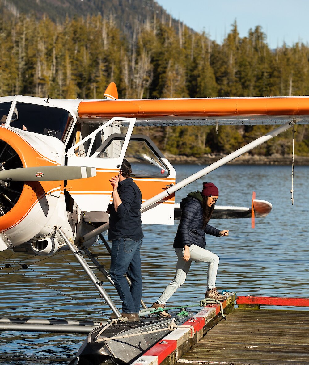 People coming out of a float plane and onto a dock