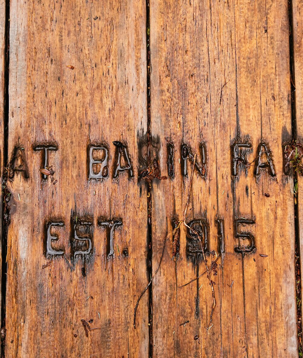 Engraving in wood that reads "Boat Basin Farm, Est. 1915."