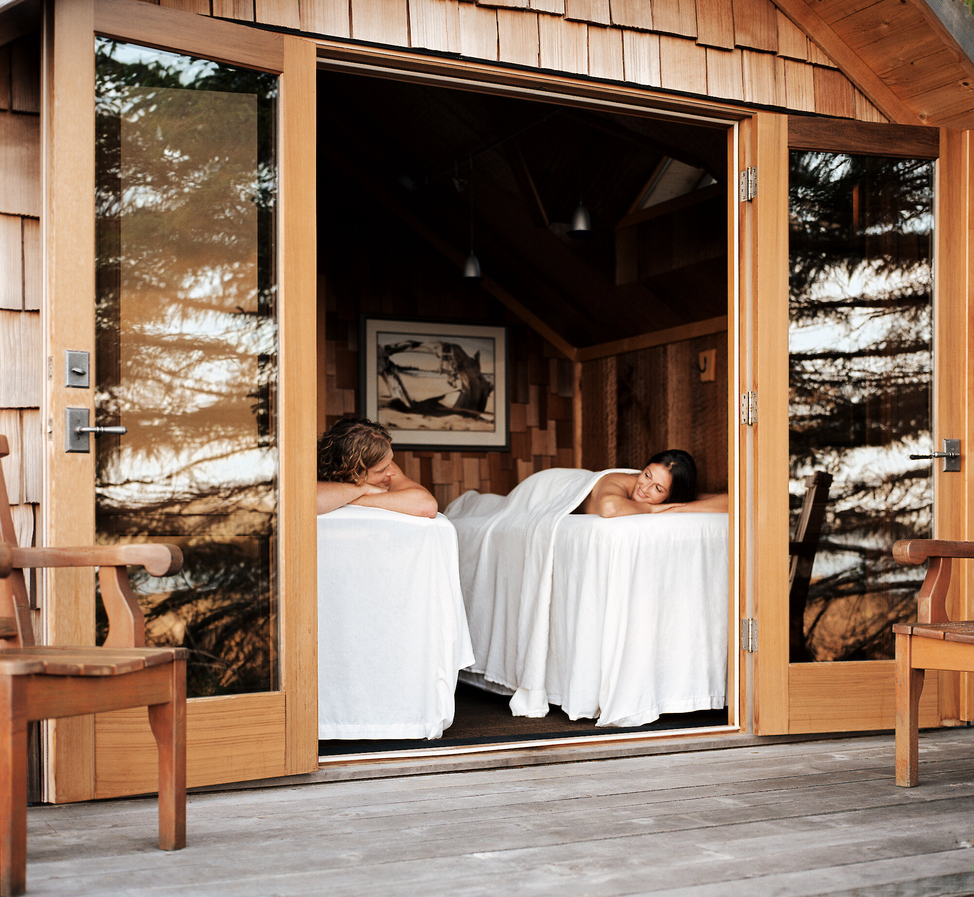 Couples massage in a hut with the doors open to the outdoors
