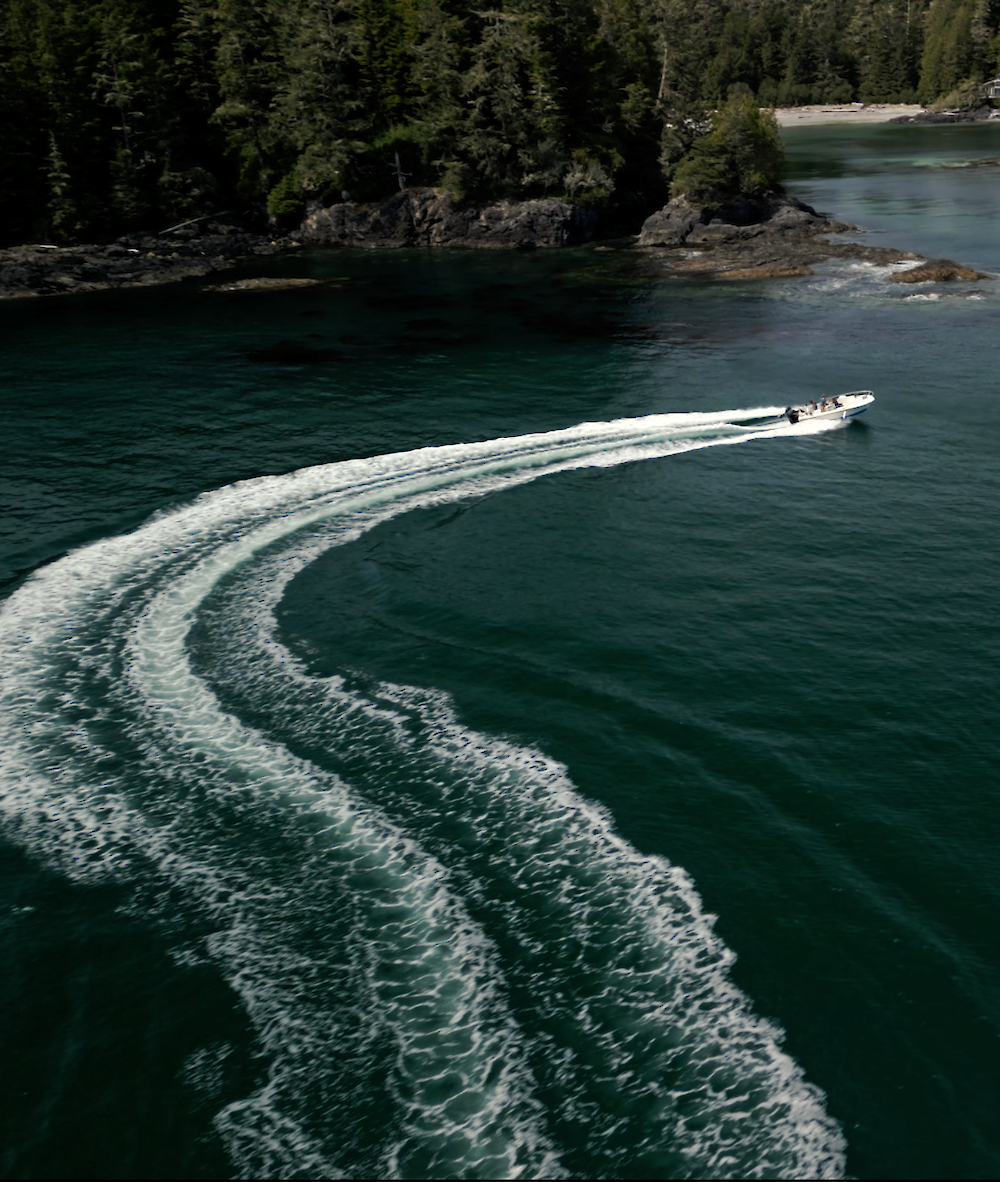 Boat on a green ocean with the wake behind it