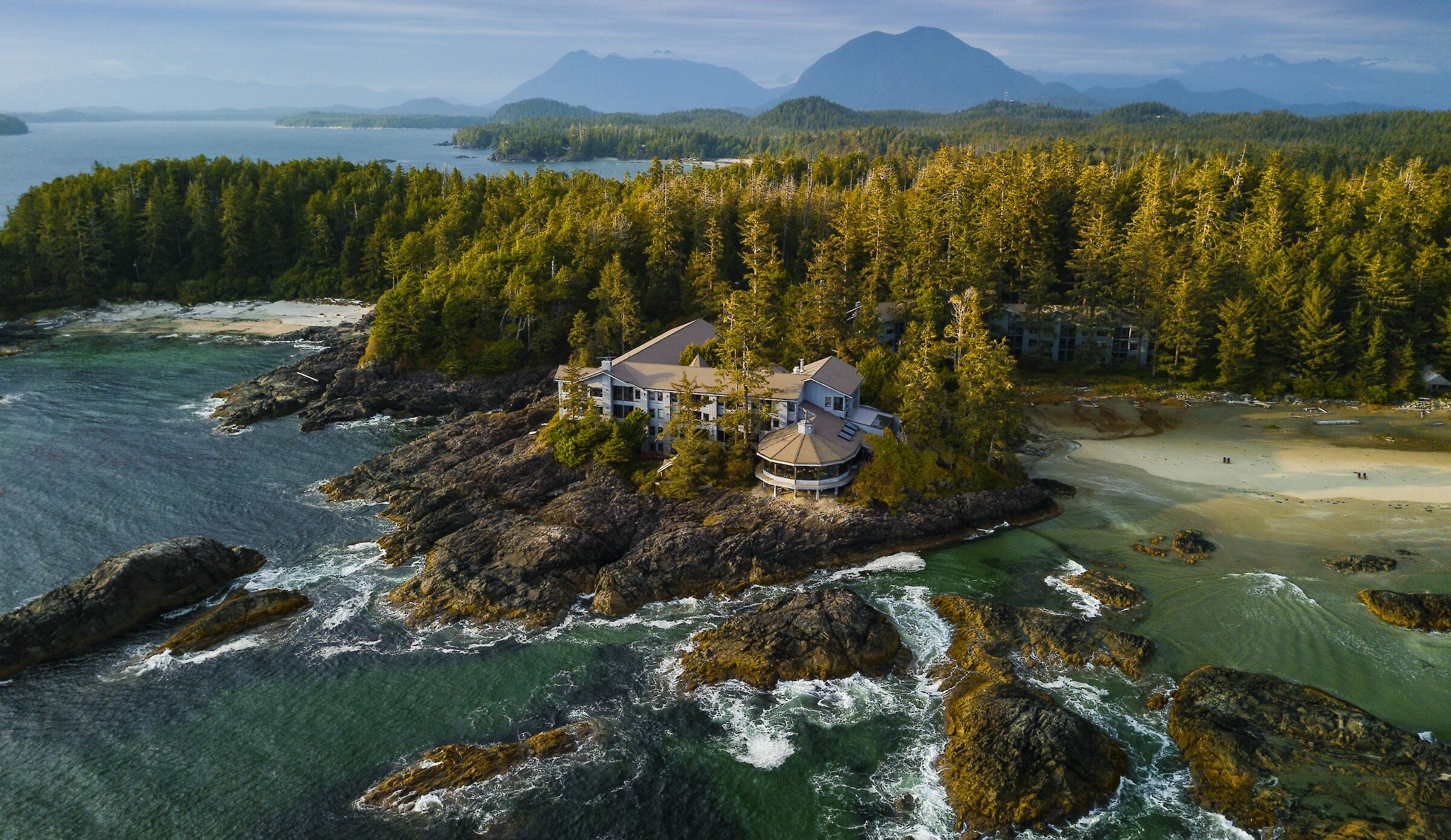 Aerial view of Wickaninnish Inn with ocean, tidal rocks and beach