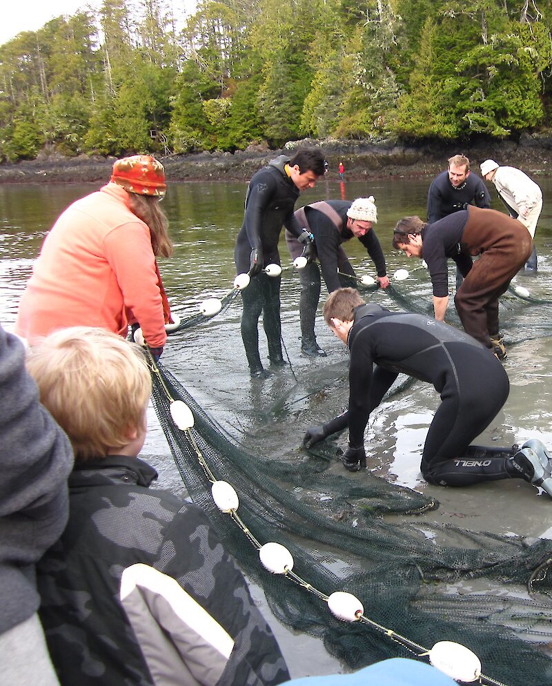 Community members cleaning out a fishing net