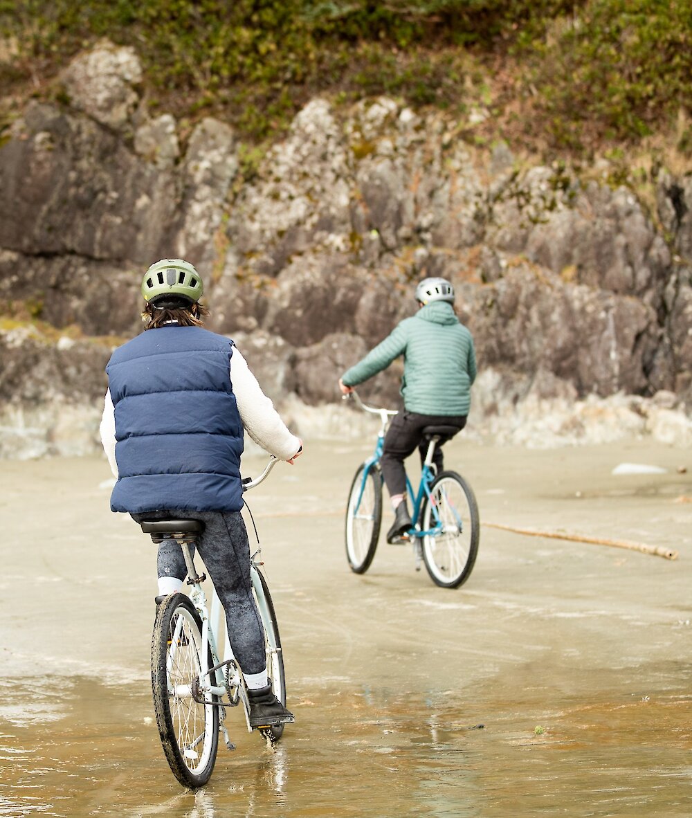 Two people biking on Long Beach near Incinerator Rock