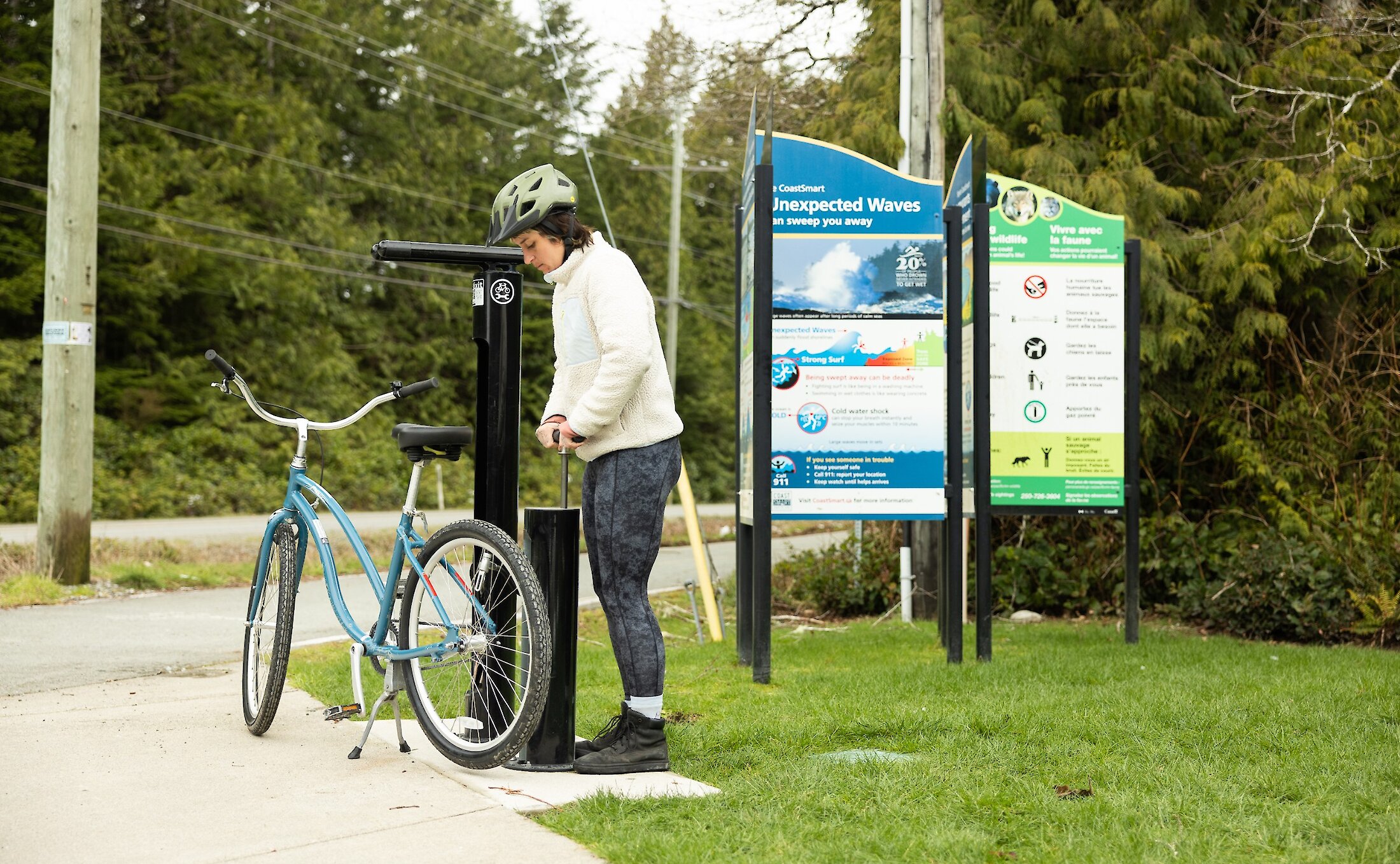 Person using the bike pump located outside of the visitor centre