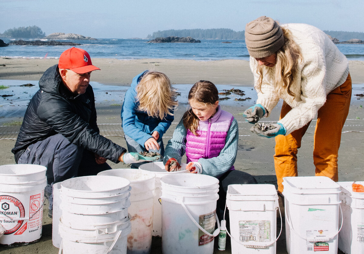 poster for Washed Up Wednesdays with a woman cleaning garbage off the beach