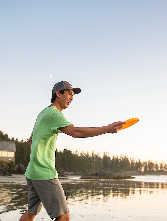 Person throwing a frisbee on Wickaninnish Beach.