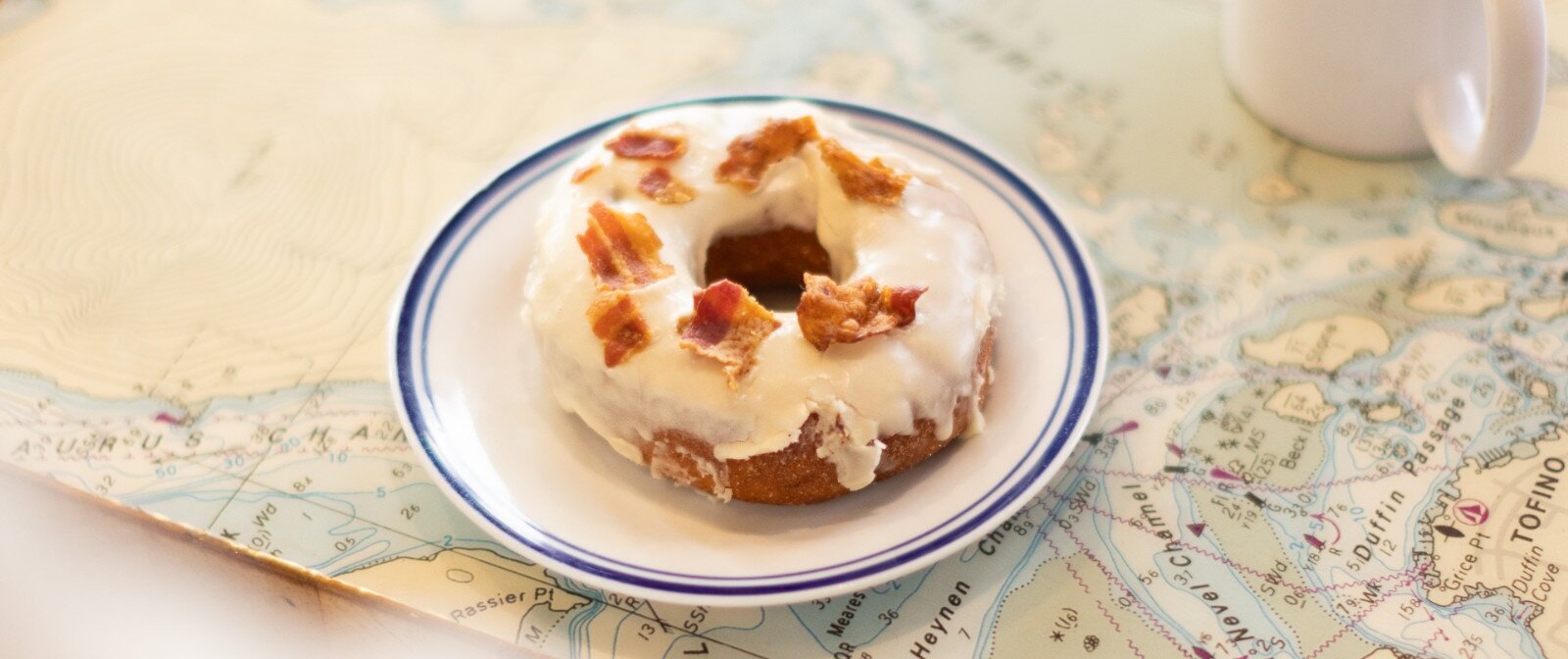 Maple bacon donut on map of Clayoquot Sound