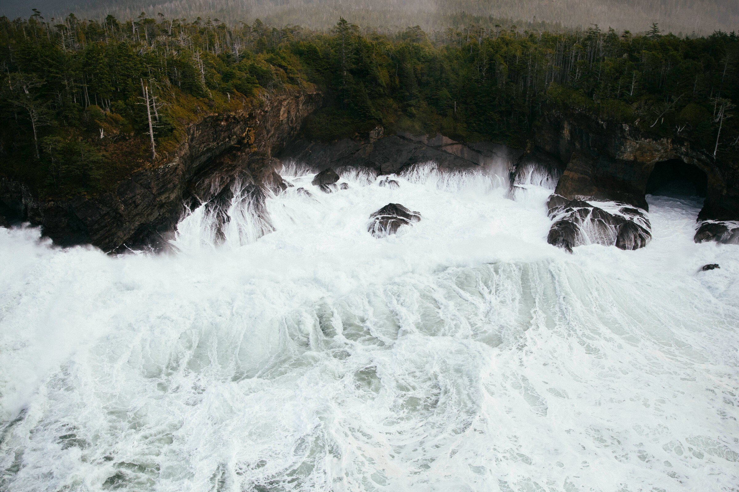 Stormy view of the ocean with large waves against the windswept coast