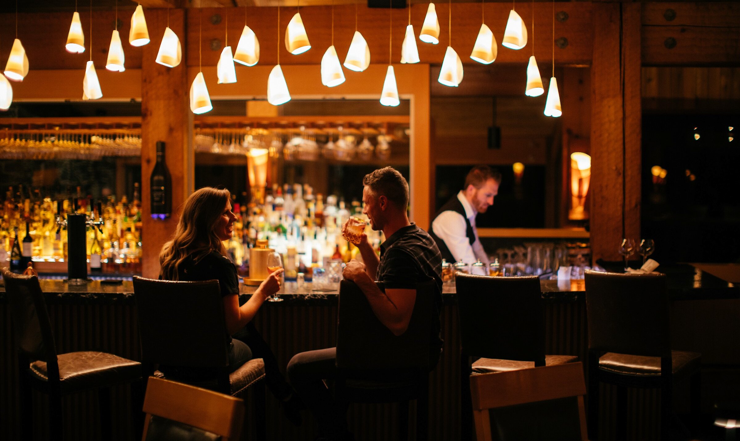 People dining at the bar at night