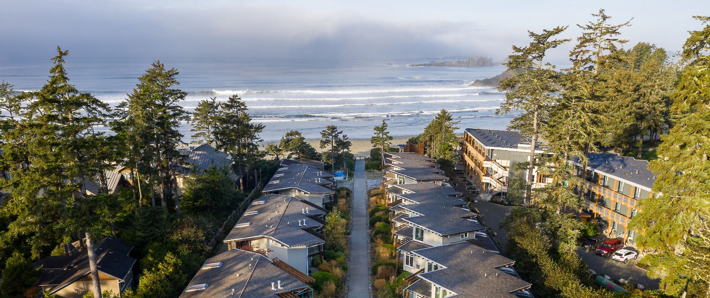 View of accommodations at Cox Bay Beach Resort with the surf in the distance