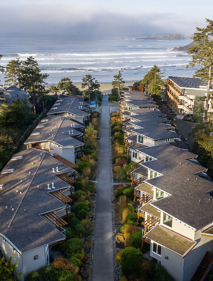 View of accommodations at Cox Bay Beach Resort with the surf in the distance