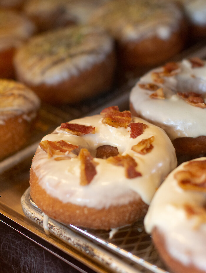 Trays of freshly baked donuts