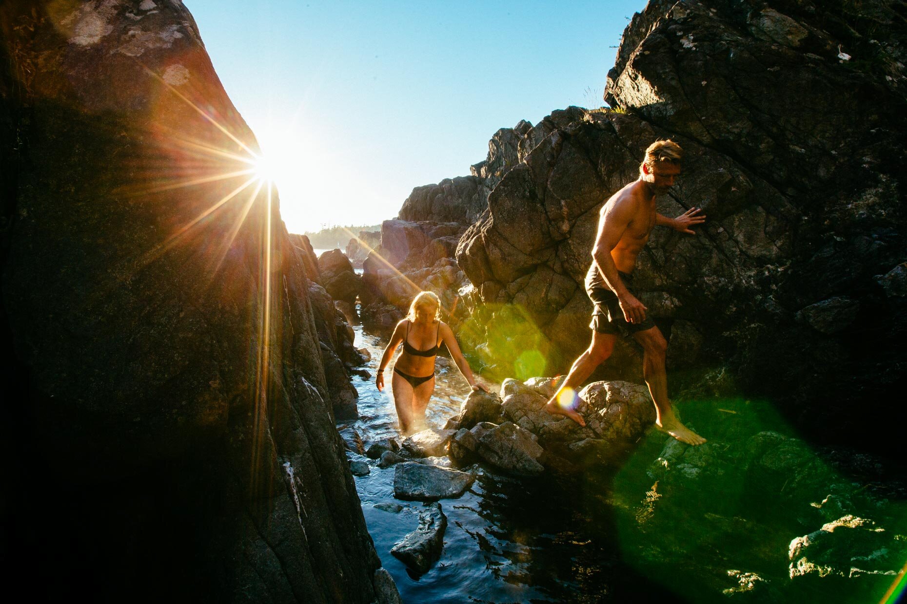 People climbing the rocks coming out of the hot springs