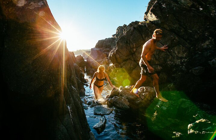 People climbing the rocks coming out of the hot springs