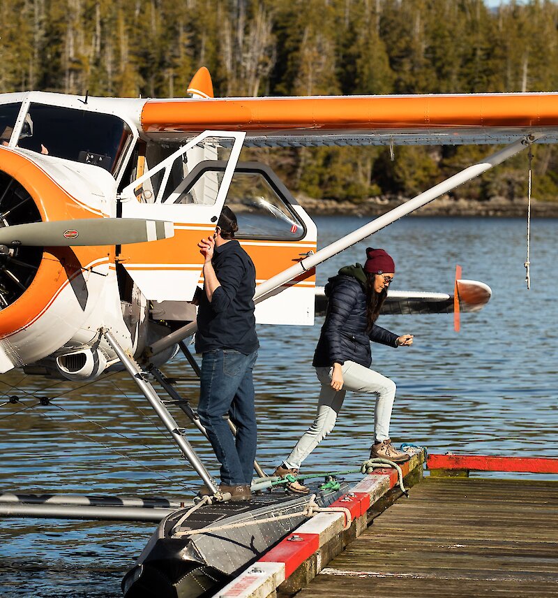 People stepping off a float plane and onto a dock