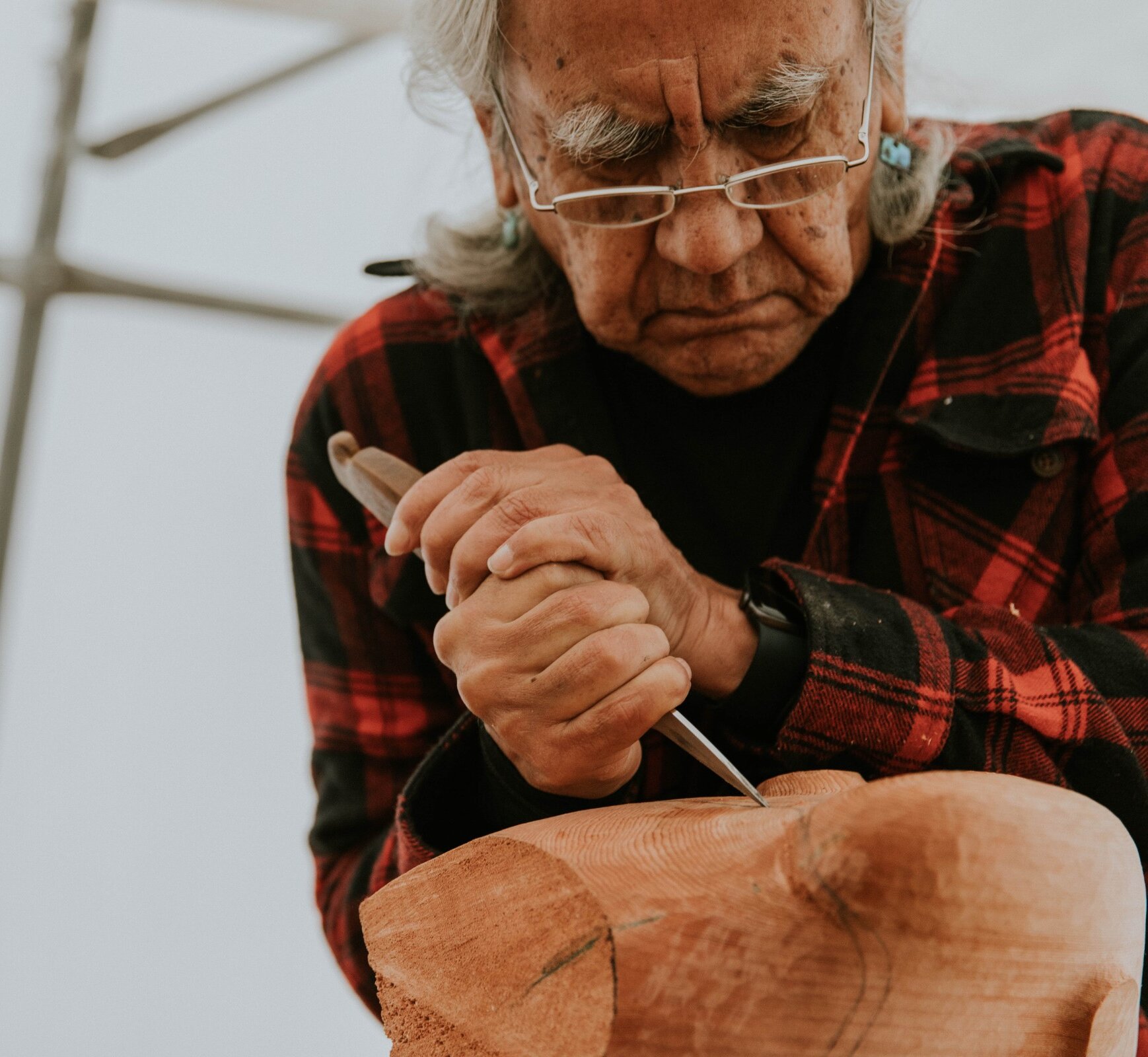 Person working on a carving in their workshop