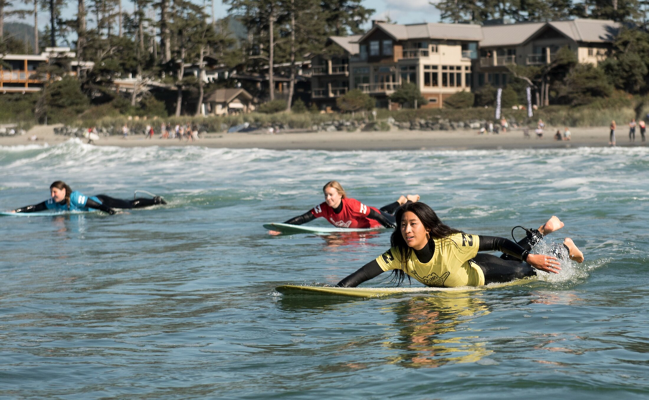 People paddling out to a break on a surf competition
